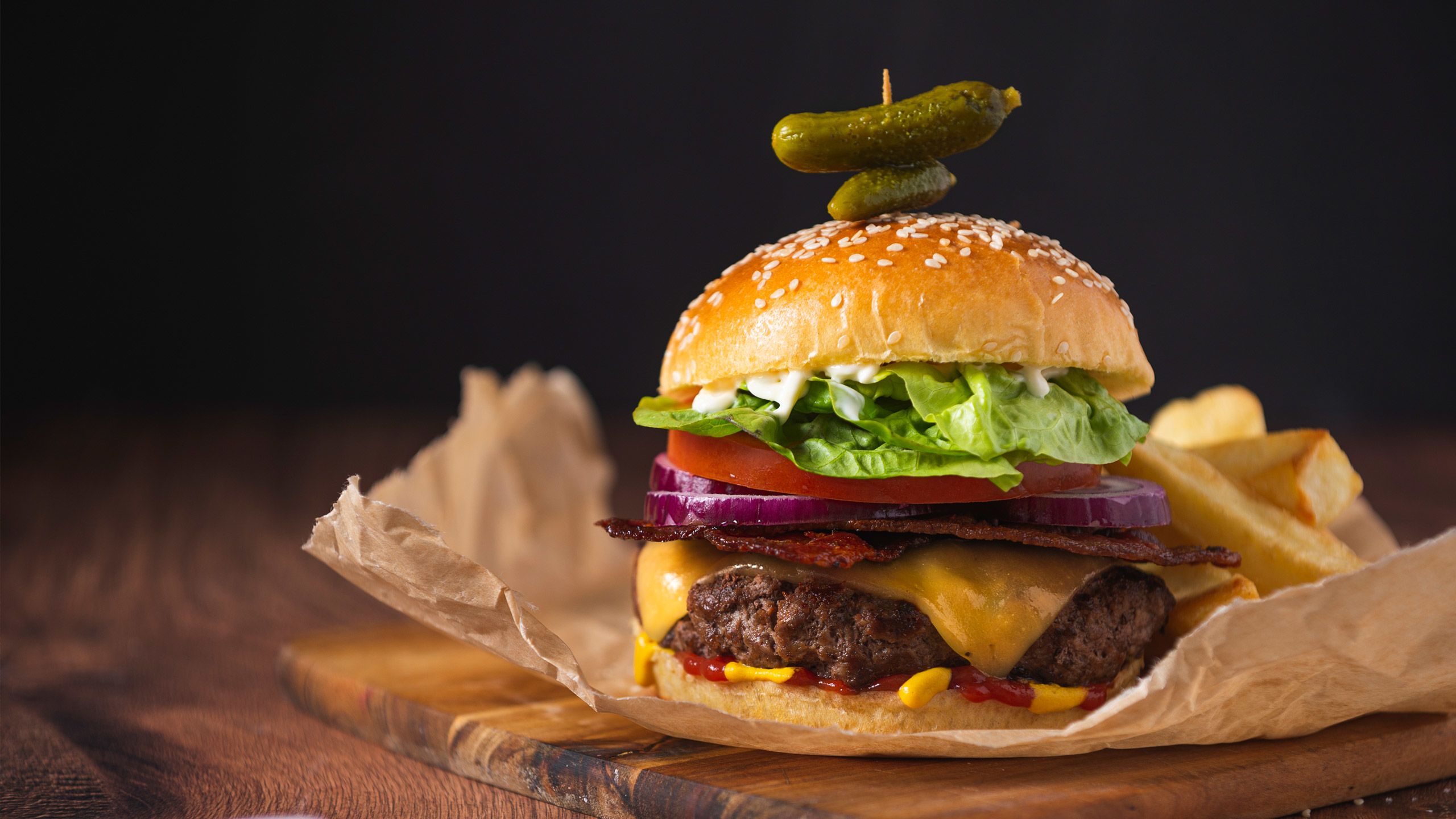 A beef burger loaded with relish, cheese, onion, lettuce and tomato